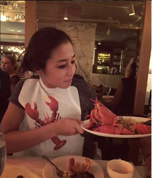 Zarina Diyas eating a Lobster